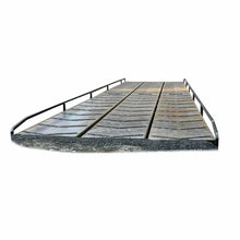 Isolated product image of a modular steel logging bridge with steel deck panels and side railings on a plain background.