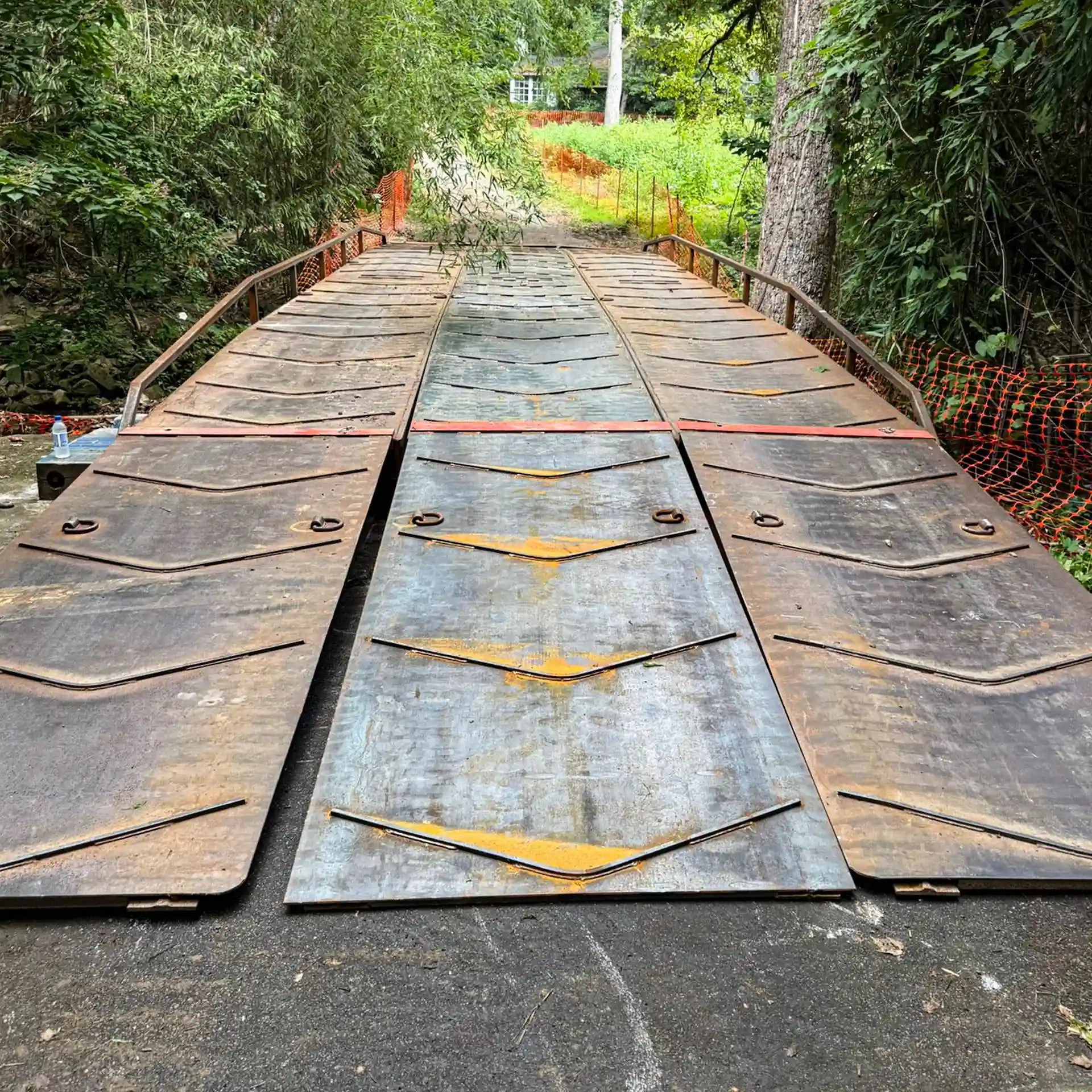 portable steel bridge in a wooded area