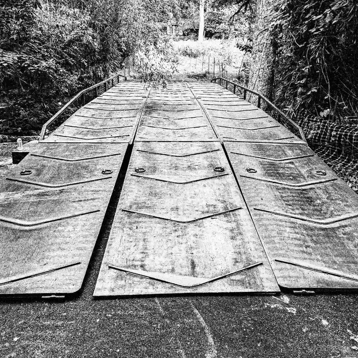 portable steel bridge in a wooded area