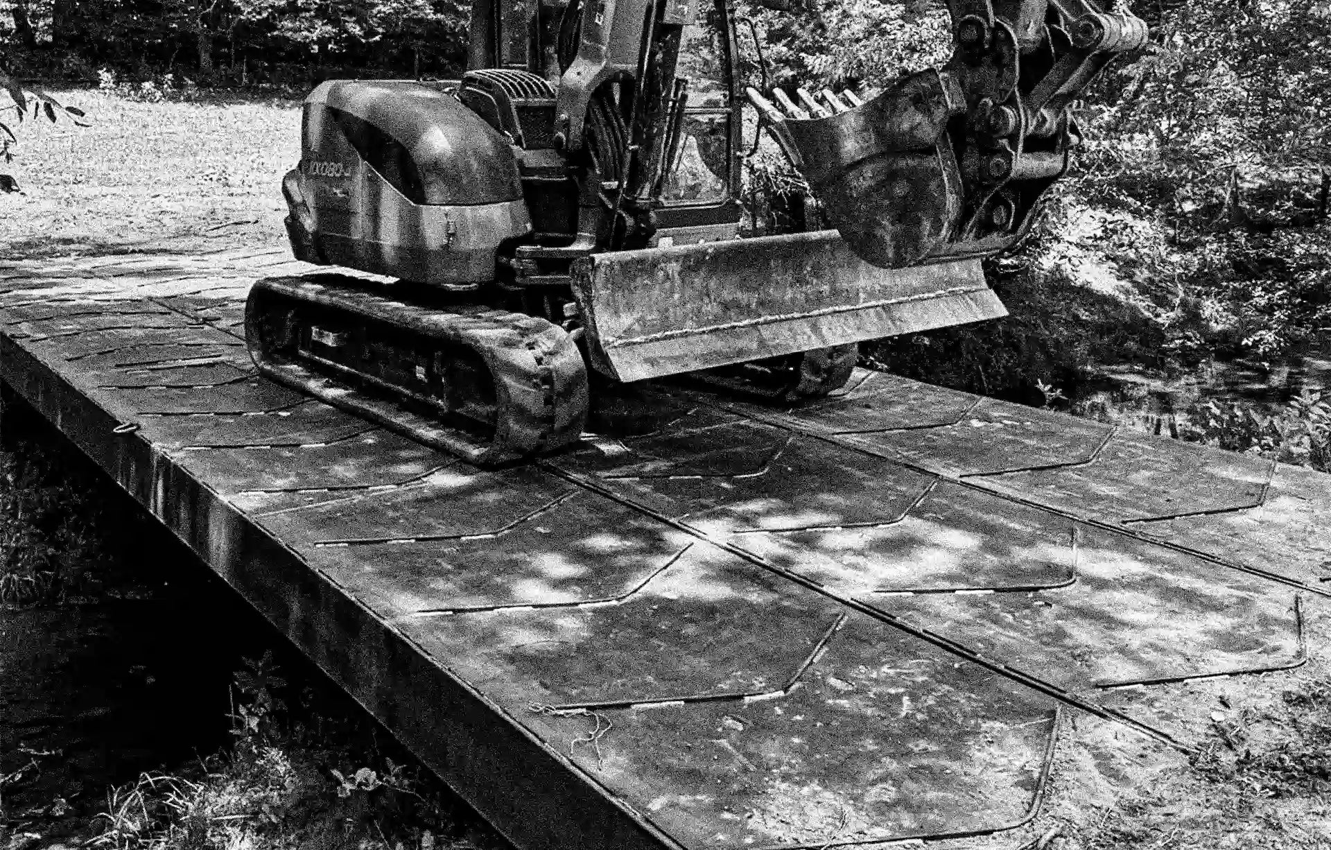 excavator on a portable steel bridge