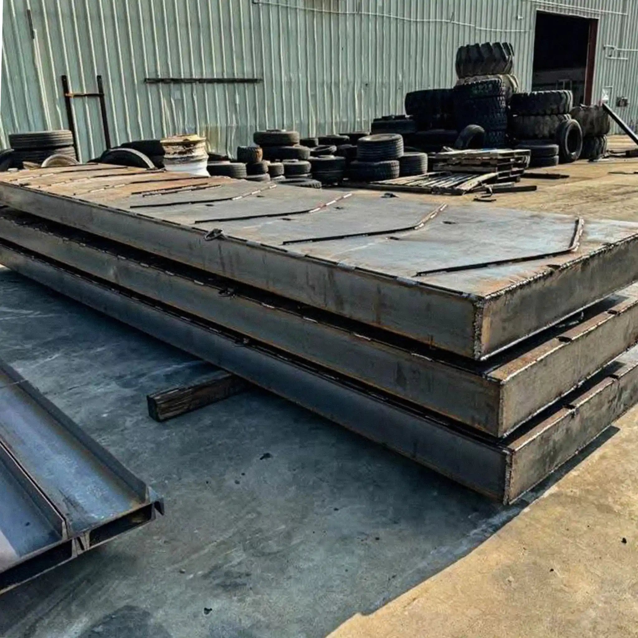 portable steel bridge components stacked in an industrial yard