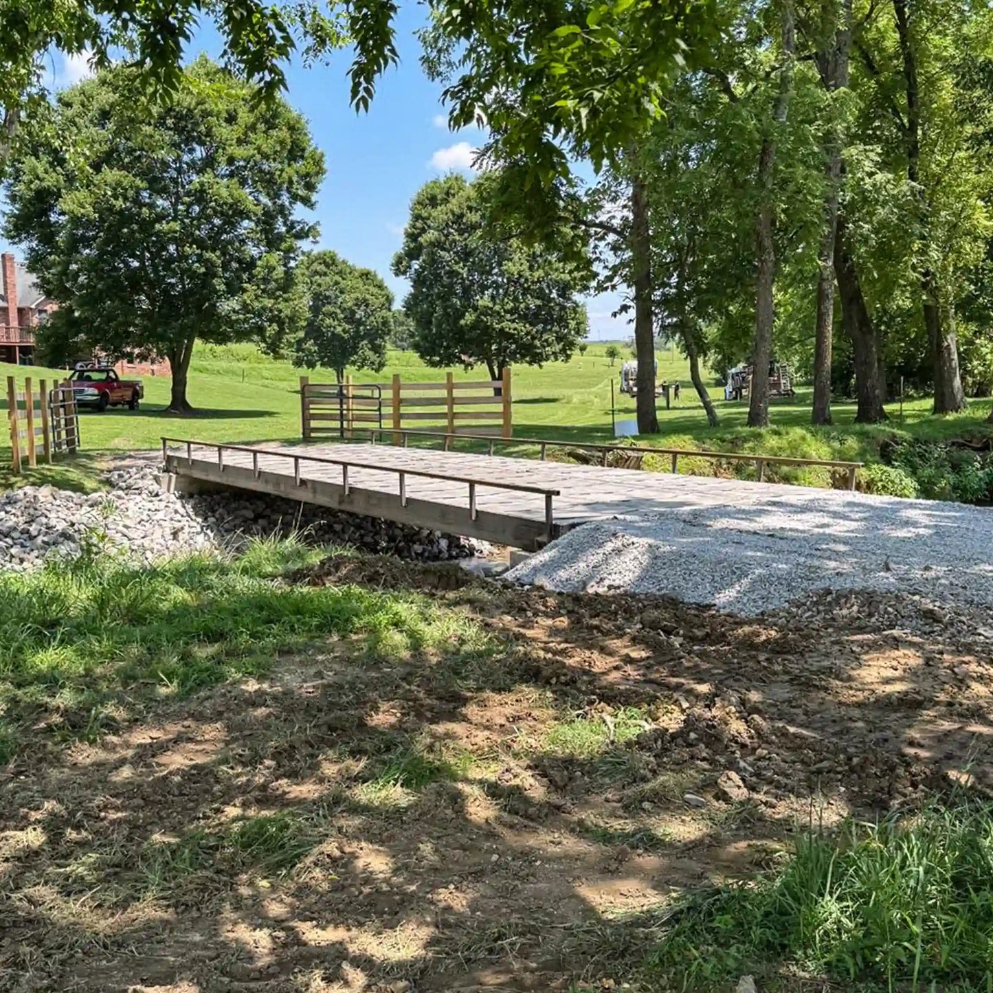 portable steel bridge over a stream in an agricultural area