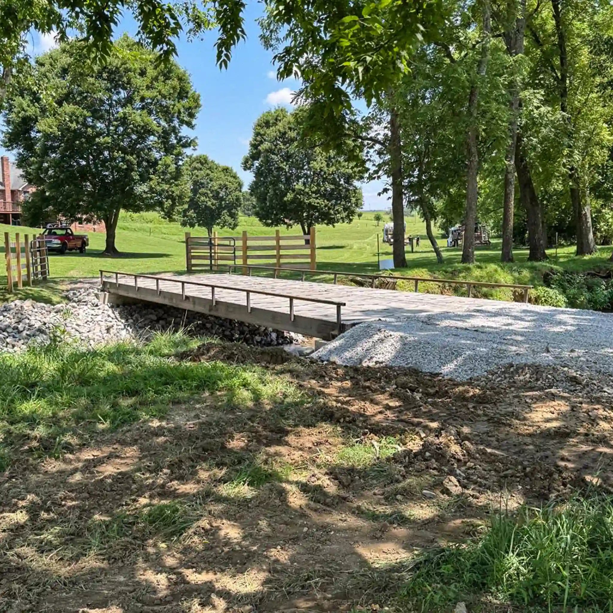 portable steel bridge over a stream in an agricultural area