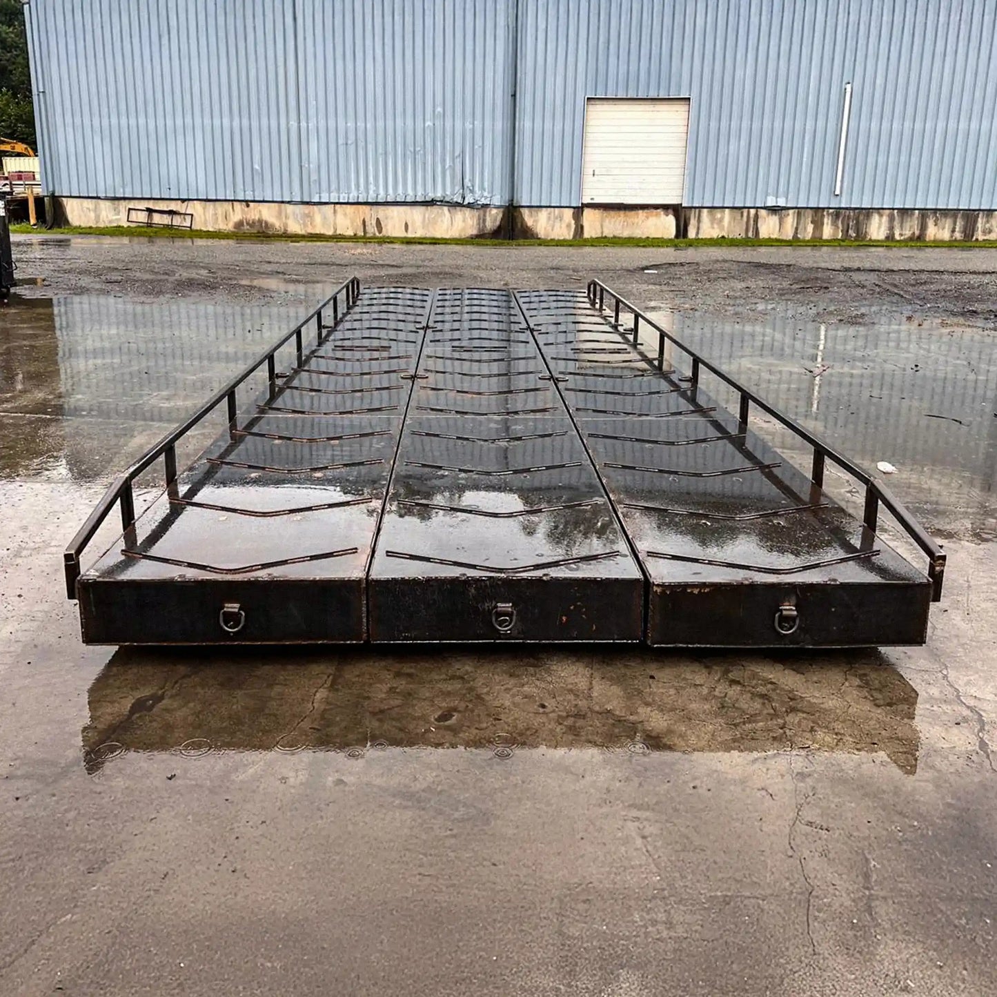 portable steel bridge with small railings in an industrial yard in the rain