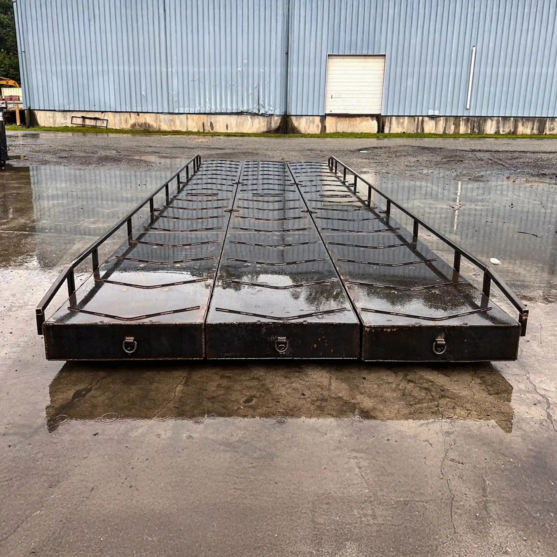 portable steel bridge with small railings in an industrial yard in the rain
