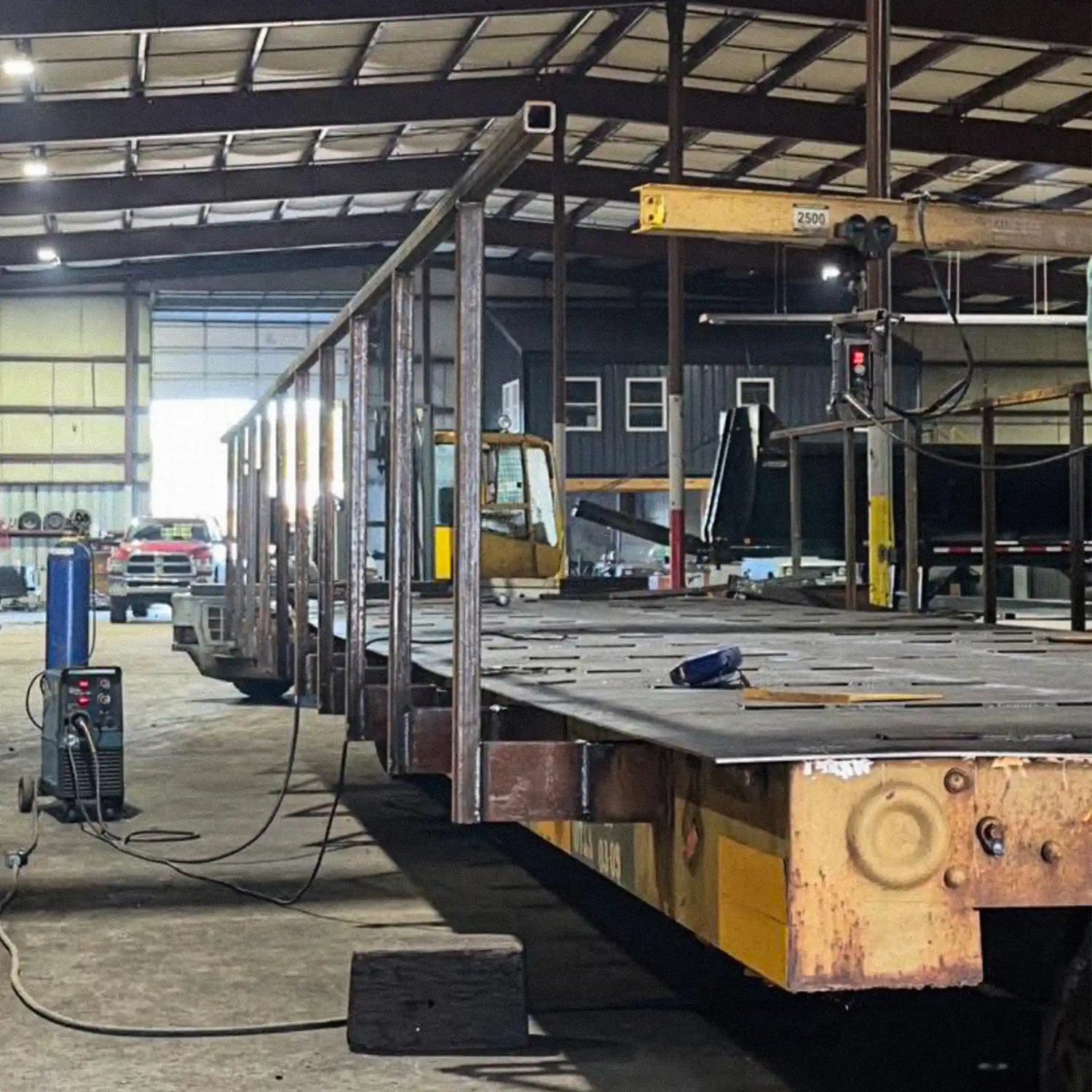 a portable steel bridge being fabricated in an industrial warehouse