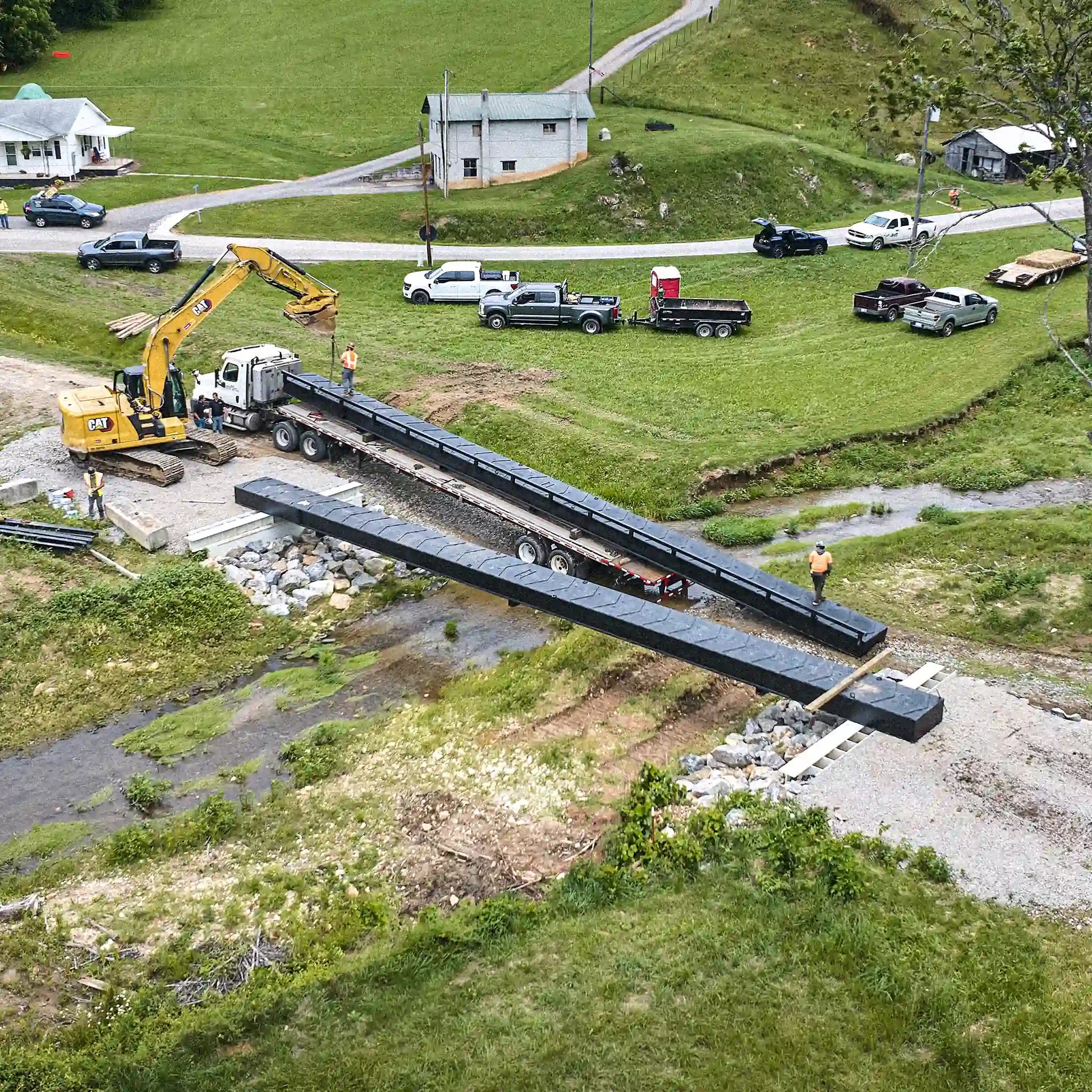 Aerial view of modular steel bridge being installed on a rural property