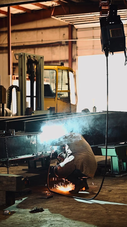 a man welding a portable steel bridge