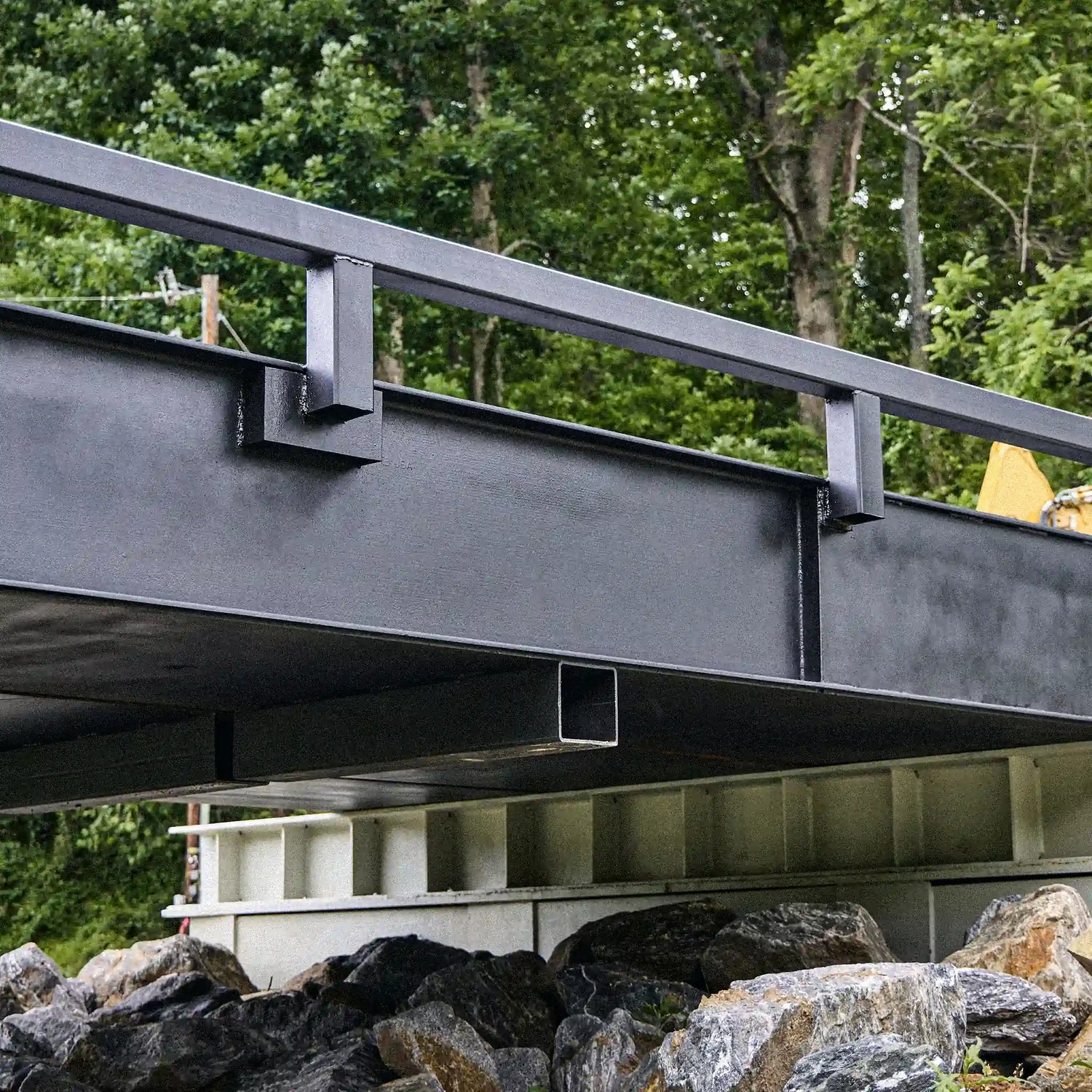 Side detail of a modular steel bridge girder and guardrail system