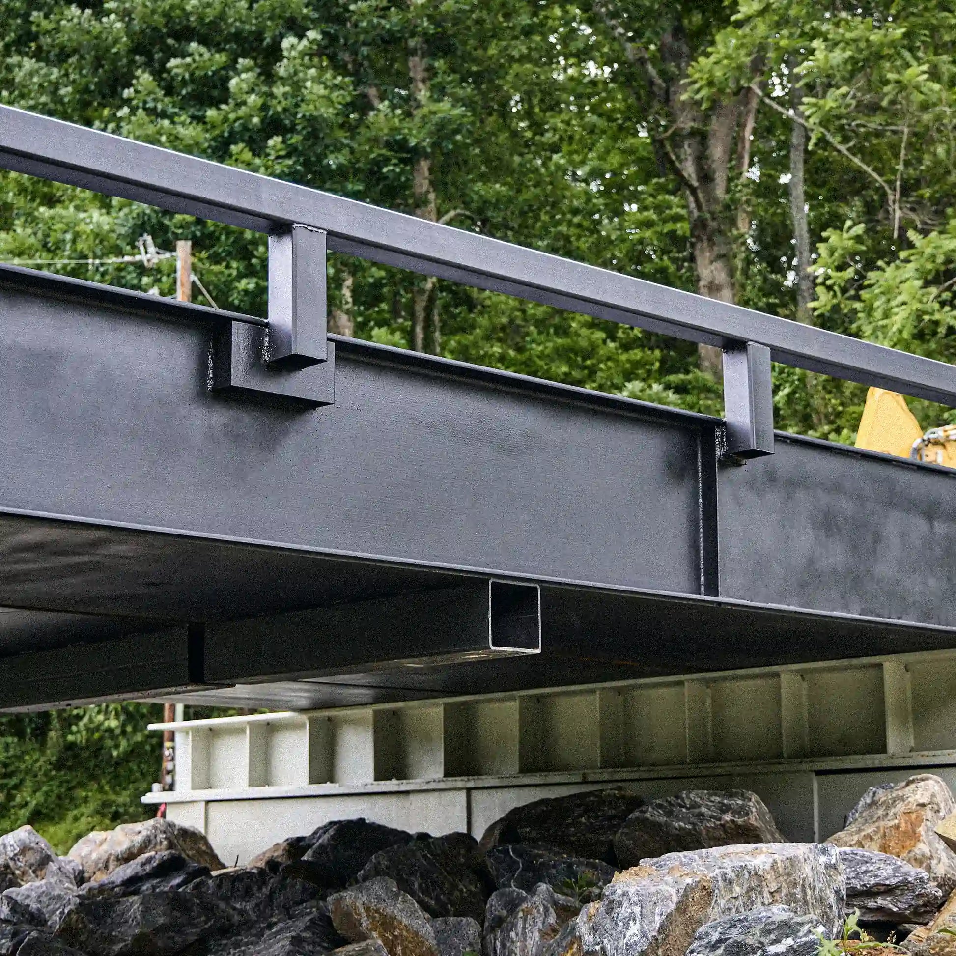 Side detail of a modular steel bridge girder and guardrail system